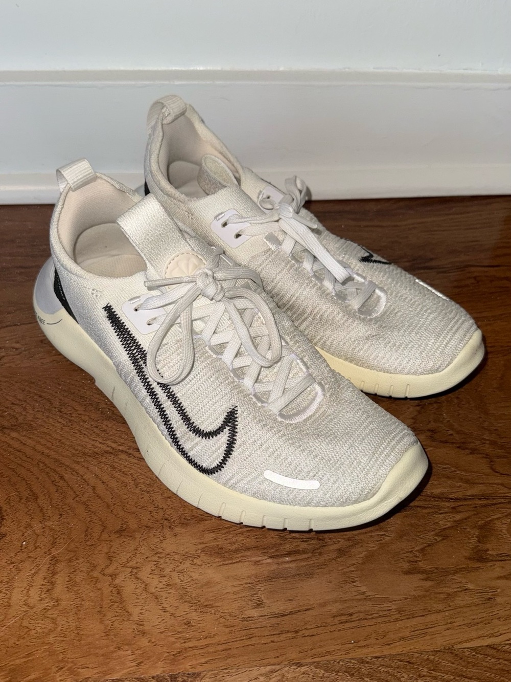 Nike Cream Flyknit Sneakers with Black Swoosh